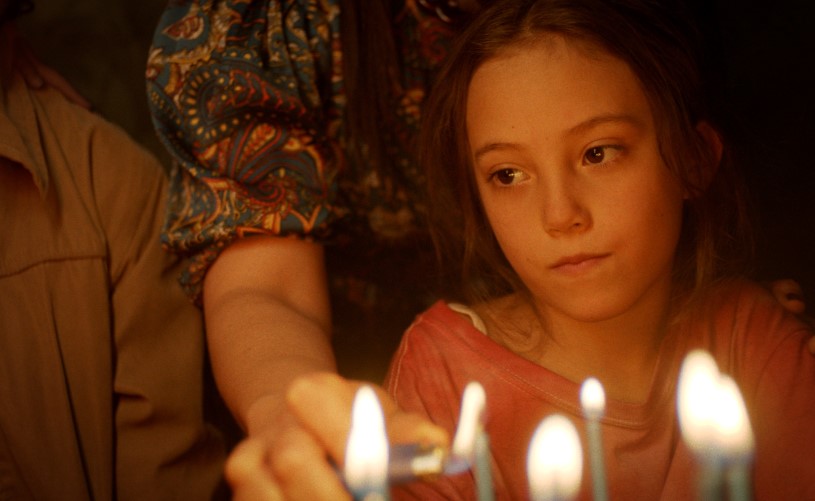 Girl looking at birthday candles